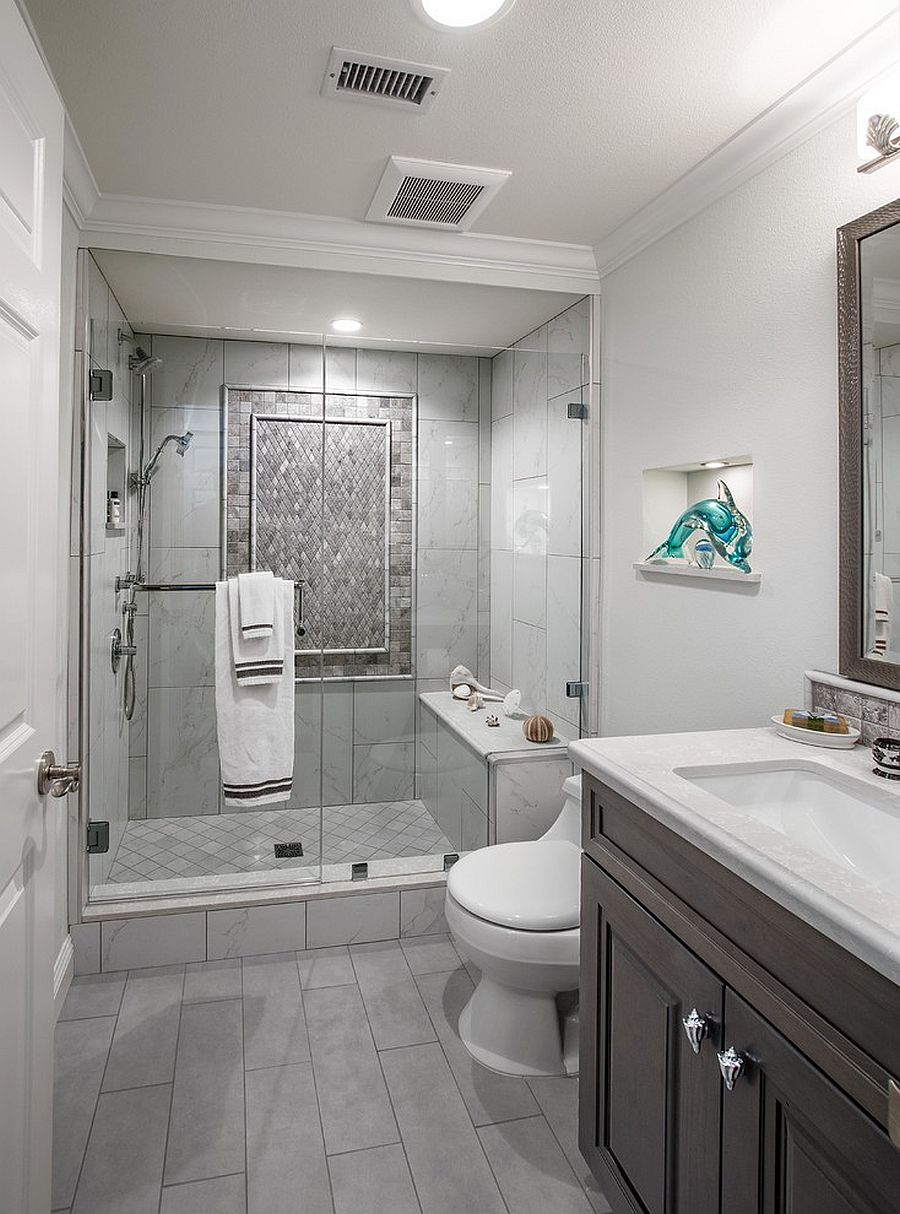 Modern bathroom with gray floor tiles and glass shower.