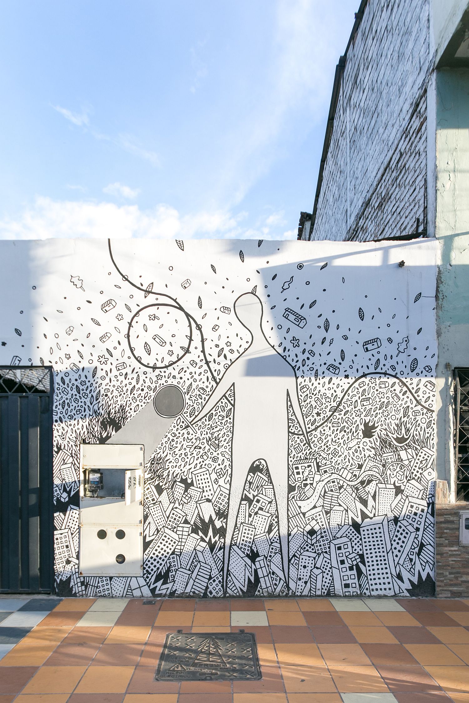 Beautiful wall mural by architect Carlos Valarezo graces the street facade of the office