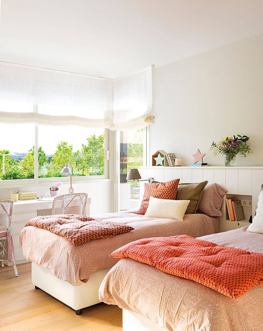 Bedding and greenery outside bring color into this little white bedroom