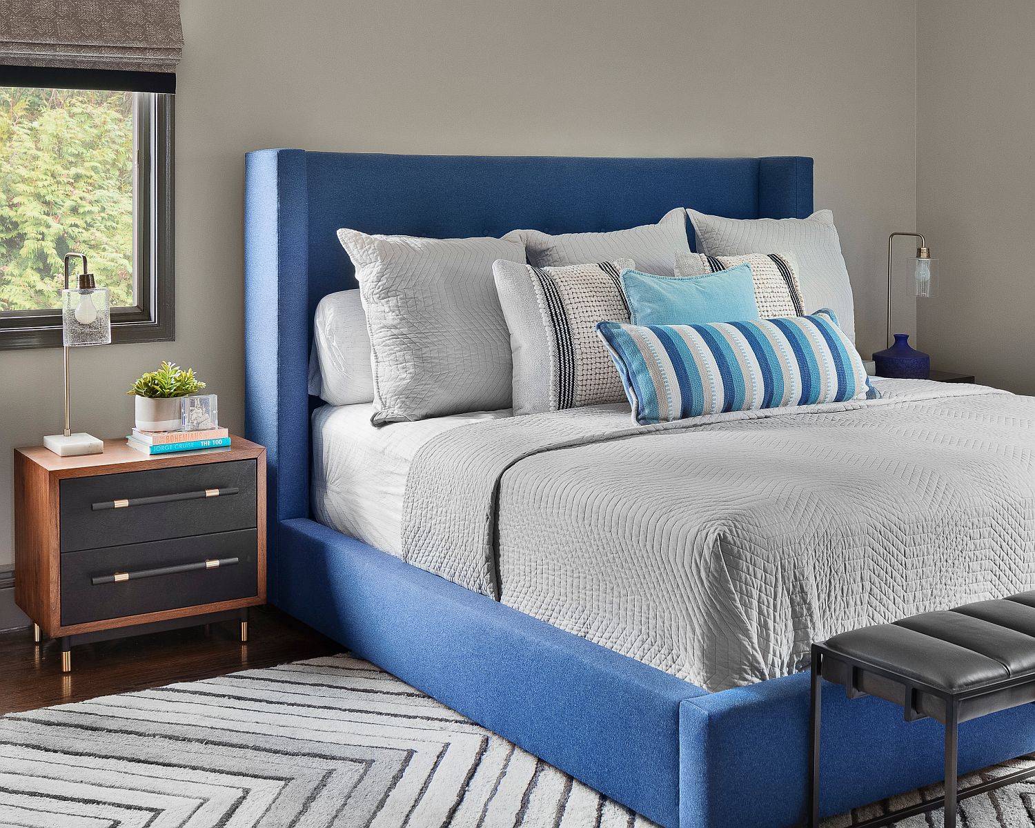 Bedside table and headboard usher in midcentury vibe into the modern bedroom with a dash of blue