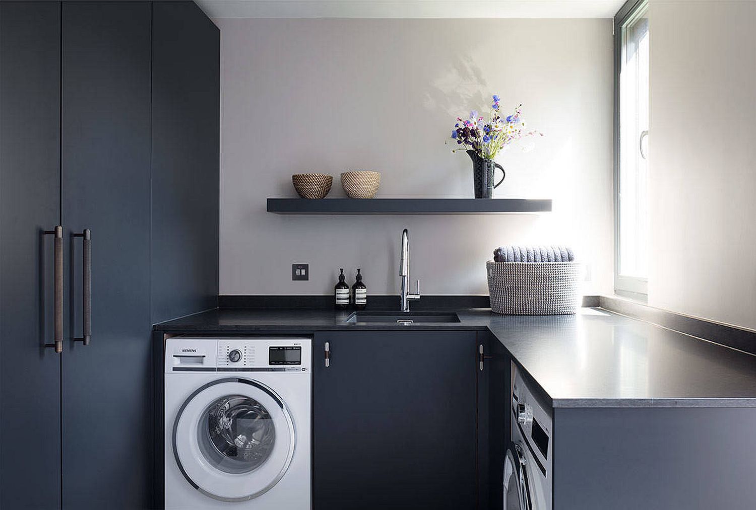 blue and gray L-shaped laundry room