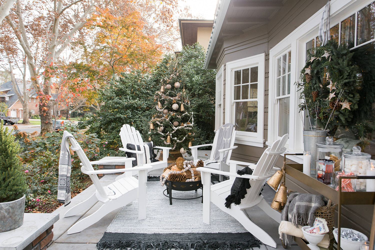 Bring the Holiday Season celebration to the front porch with some chairs and a Christmas tree in the corner
