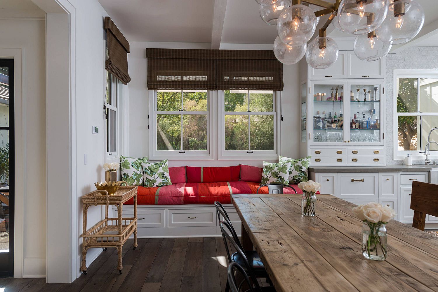 Built-in bench and window seat for the kitchen with colorful cushions and storage options