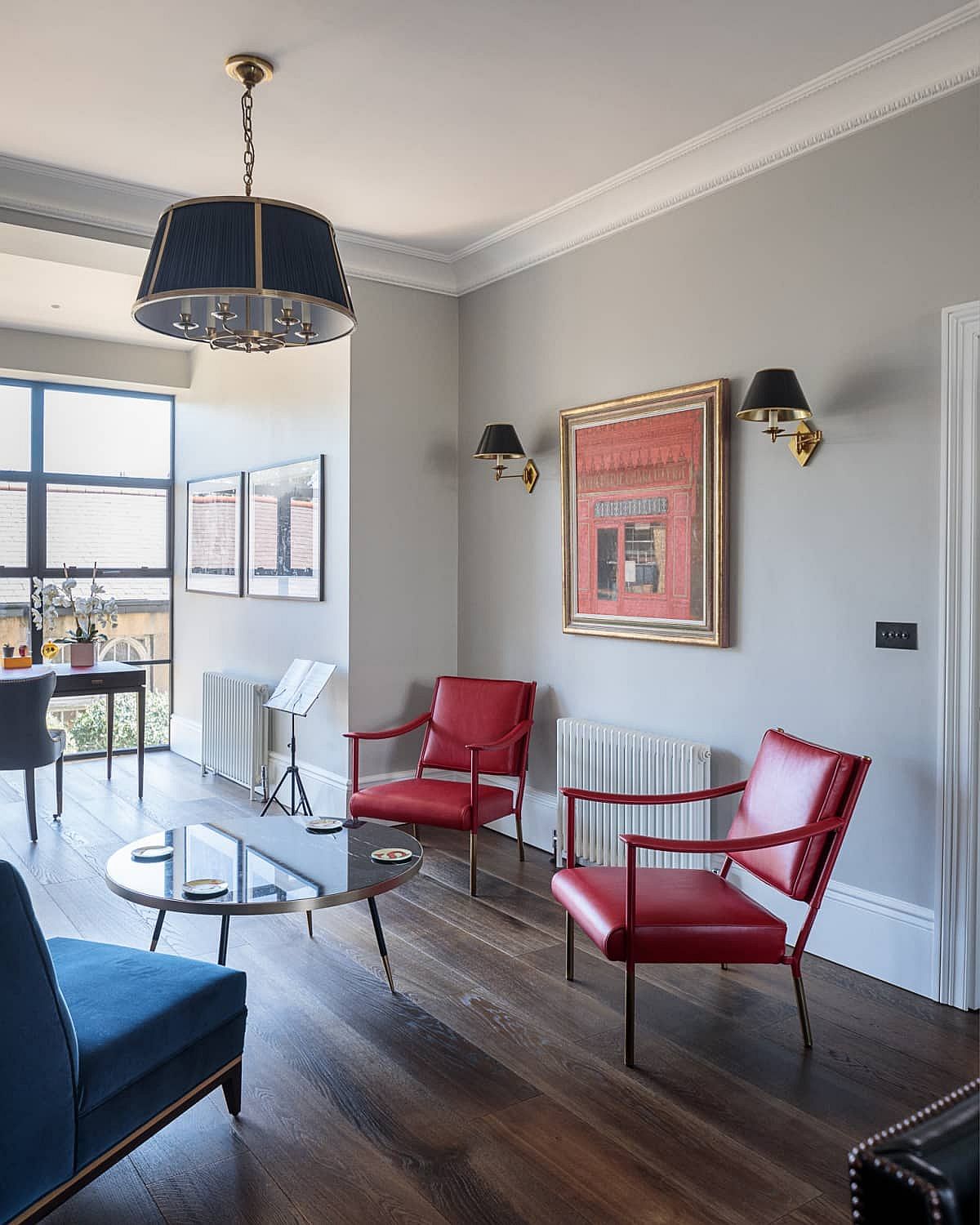 Chairs, wall art and sofa bring brightness to the classic interior in neutral hues