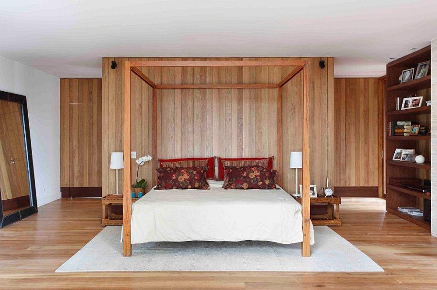 Classic four-poster bed for the modern bedroom with accent wood wall