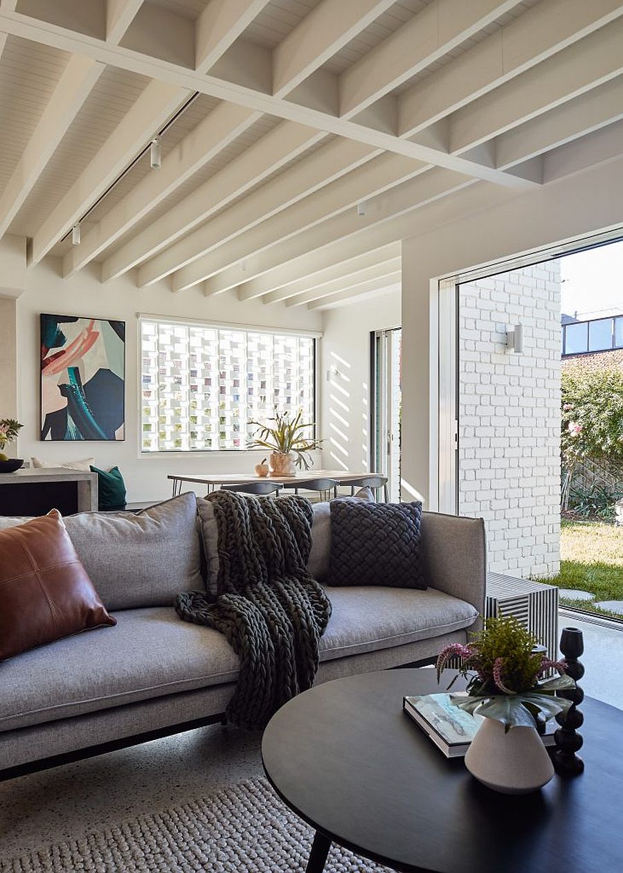 Contemporary living area, kitchen and dining room of the house connected to the garden visually