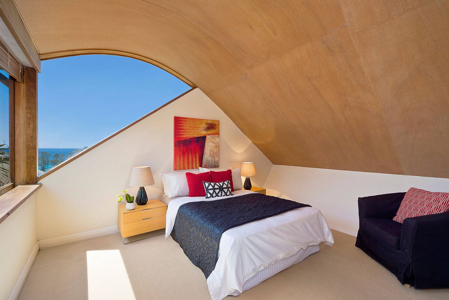 Curved wooden ceiling and smart windows create a cool and small master bedroom in Sydney