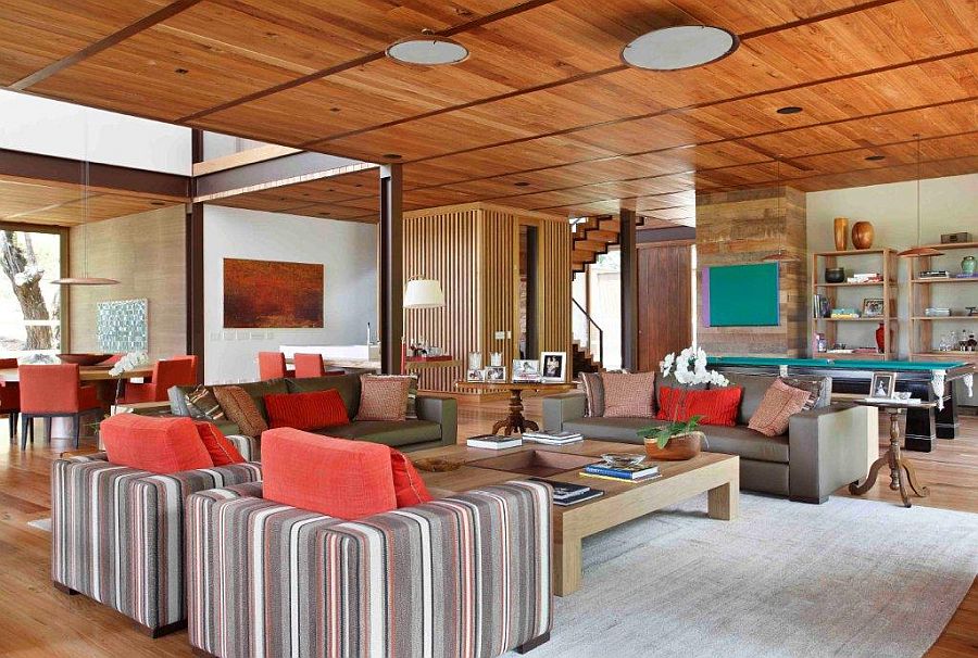 Cushions and accent pillows bring color to the spacious living room in wood and white