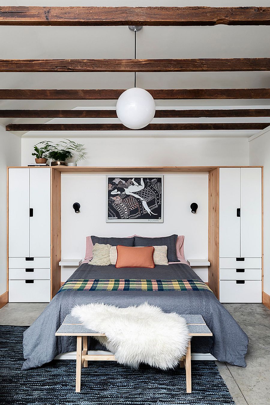 Custom white and wood bedroom wardrobe unit saves space in the small interior