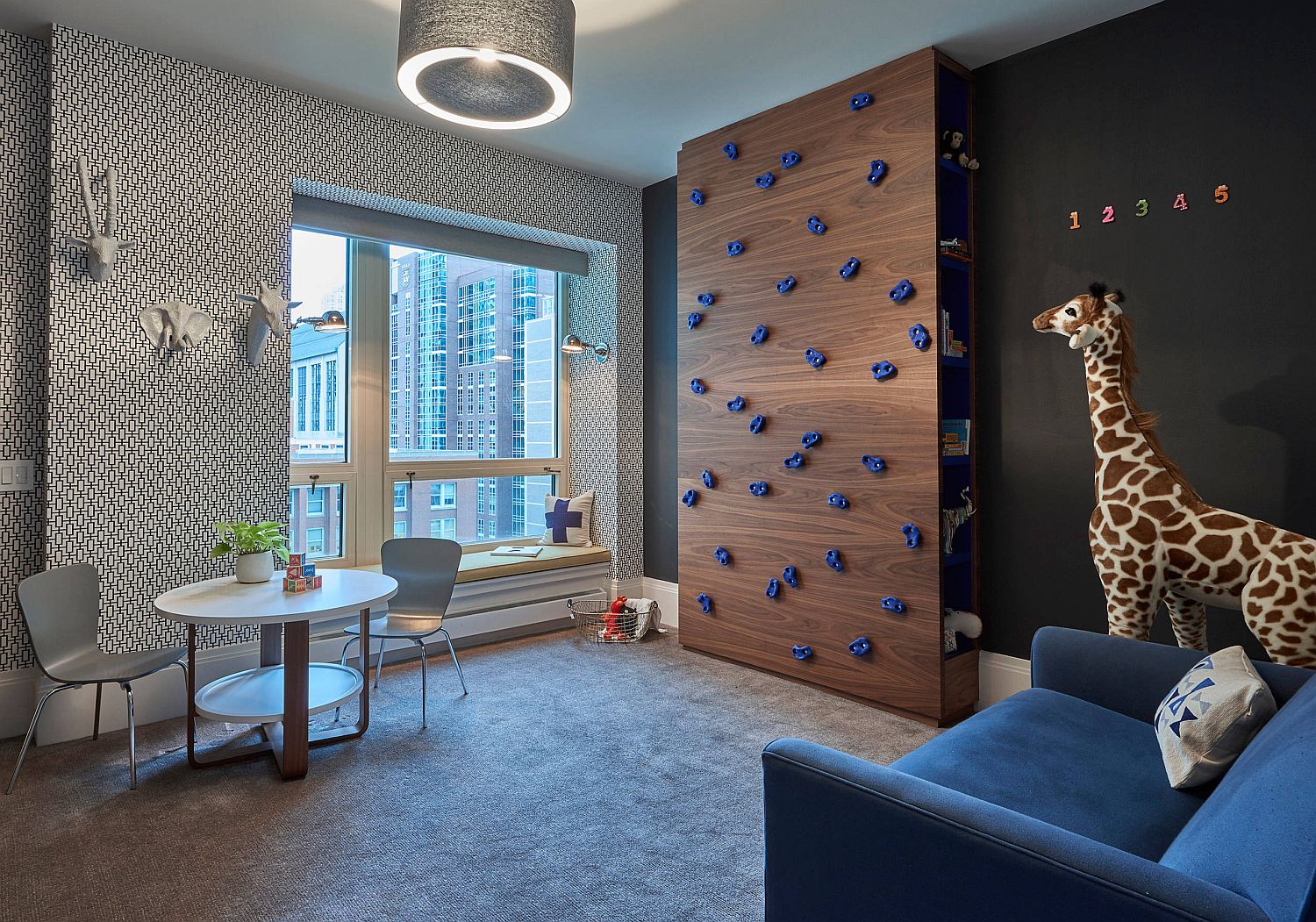 Custom wooden climbing wall for the kids' room also serves as a bookshelf