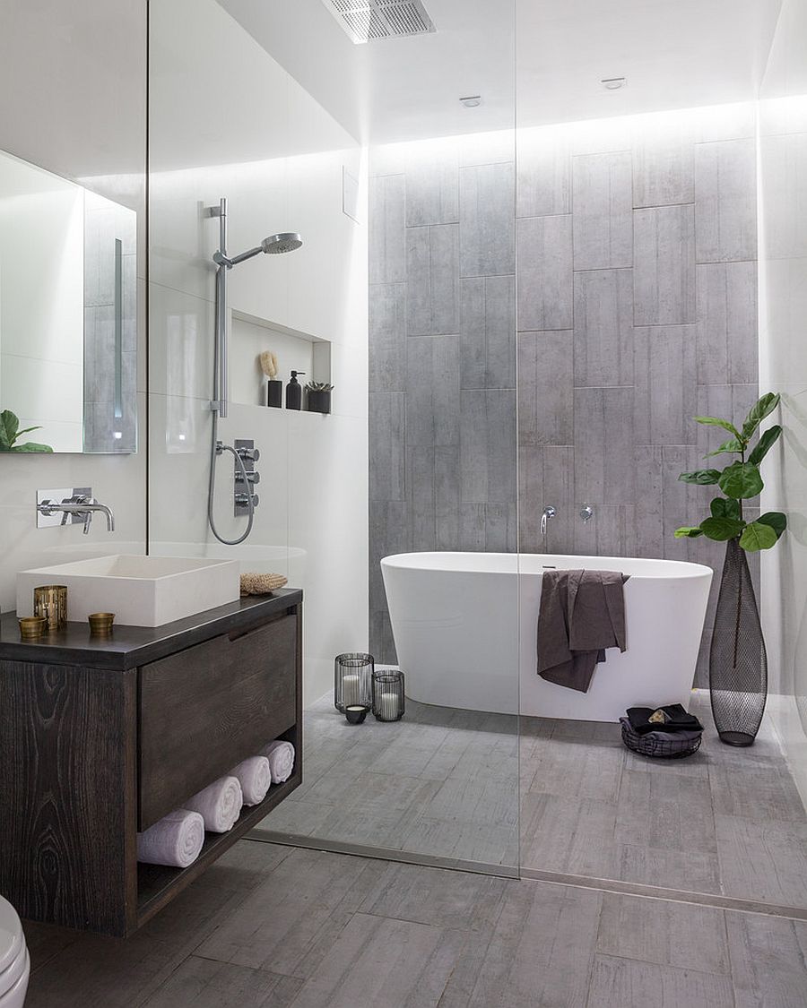 gray bathroom with glass shower.