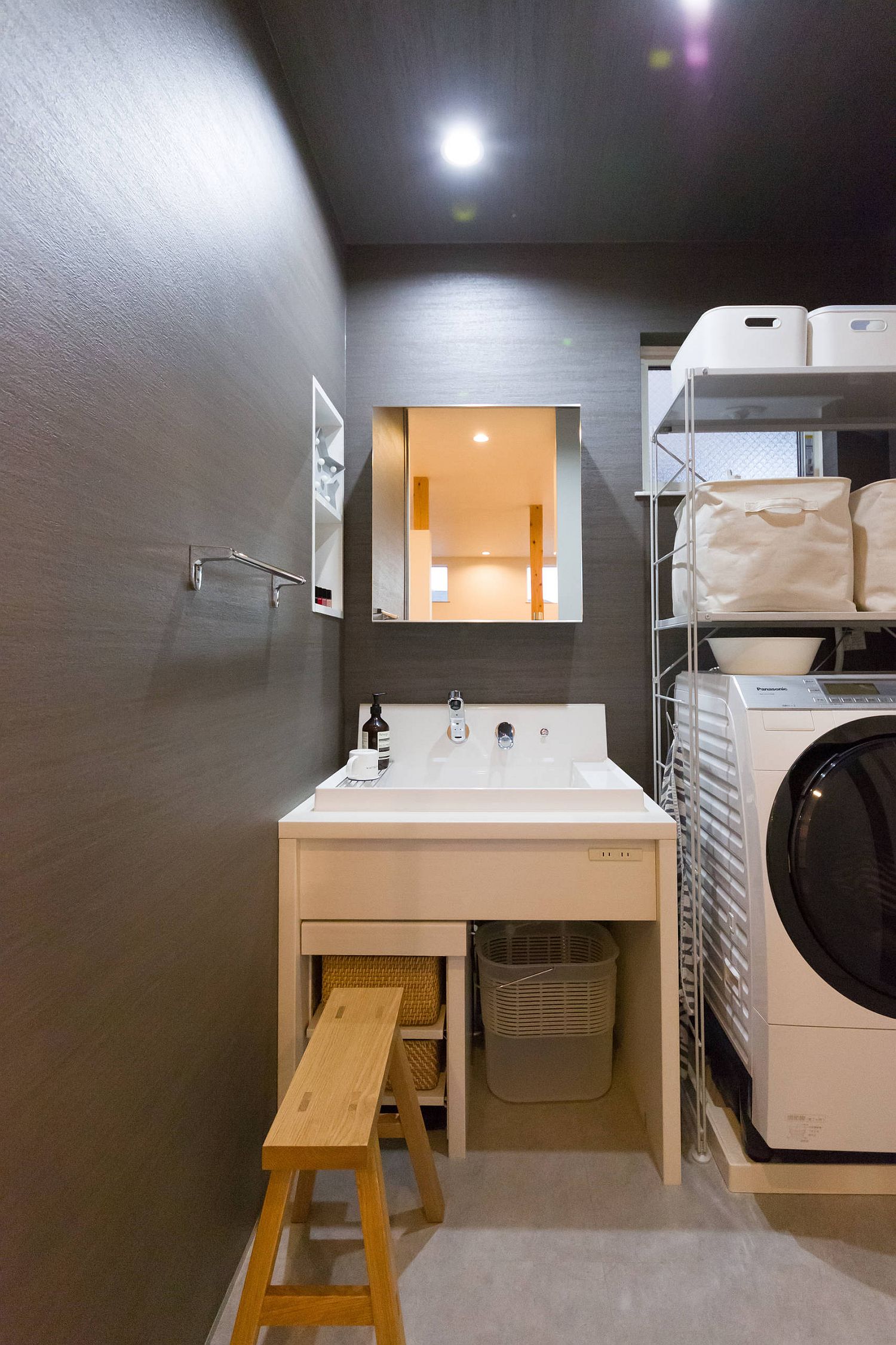 Dark backdrop for the small laundry with plenty of space-savvy features