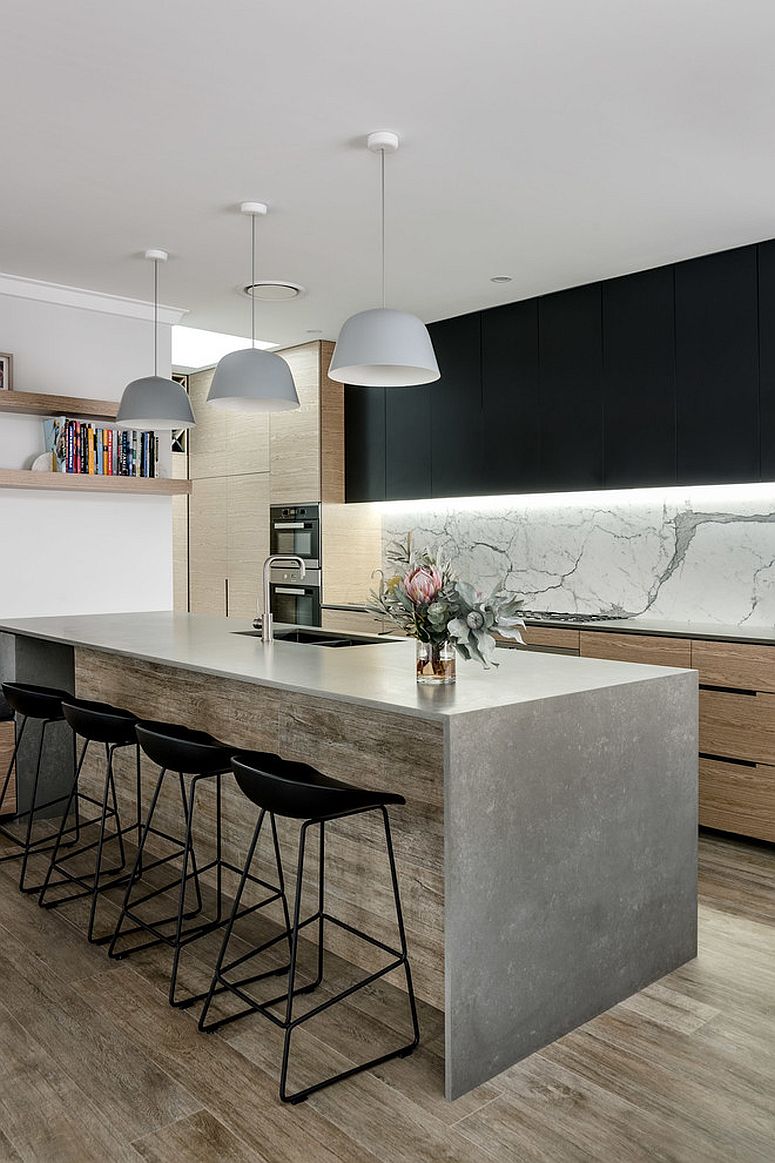 Dark cabinets and pendants in the light white kitchen with a unique backdrop