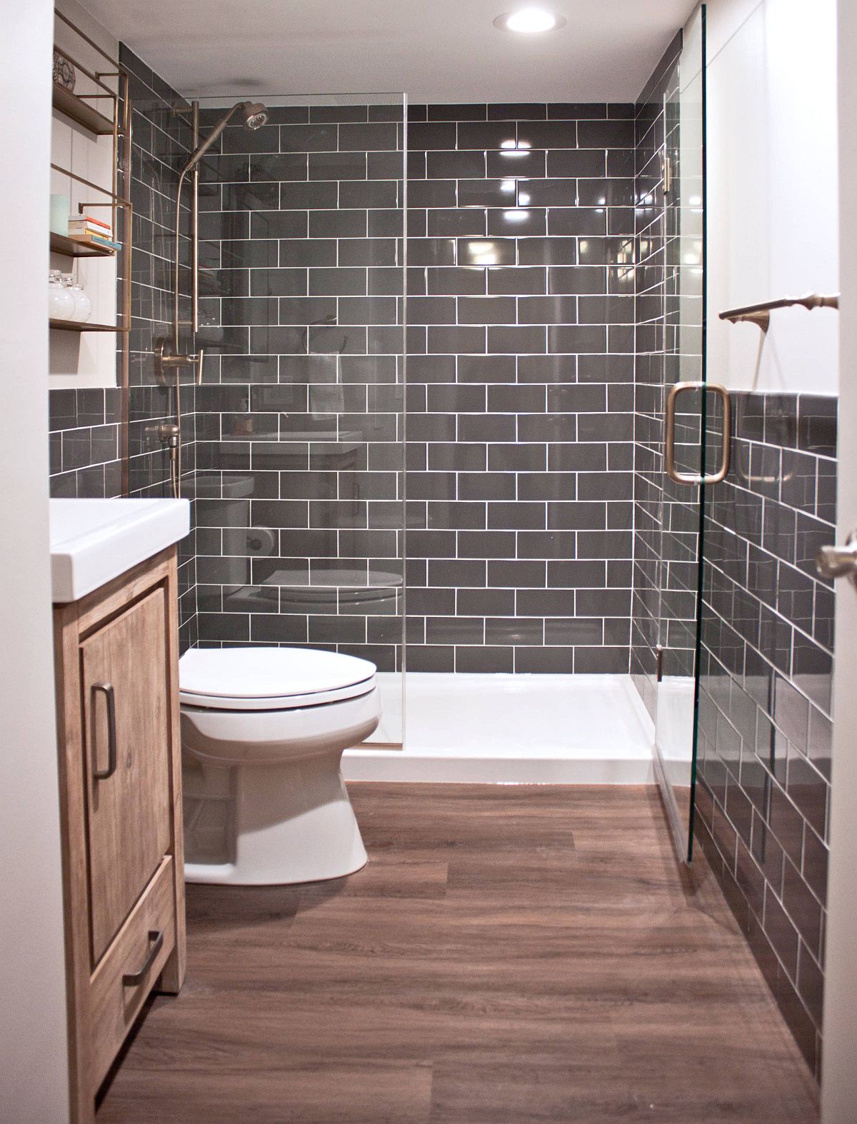 Small dark gray bathroom with wood floors.