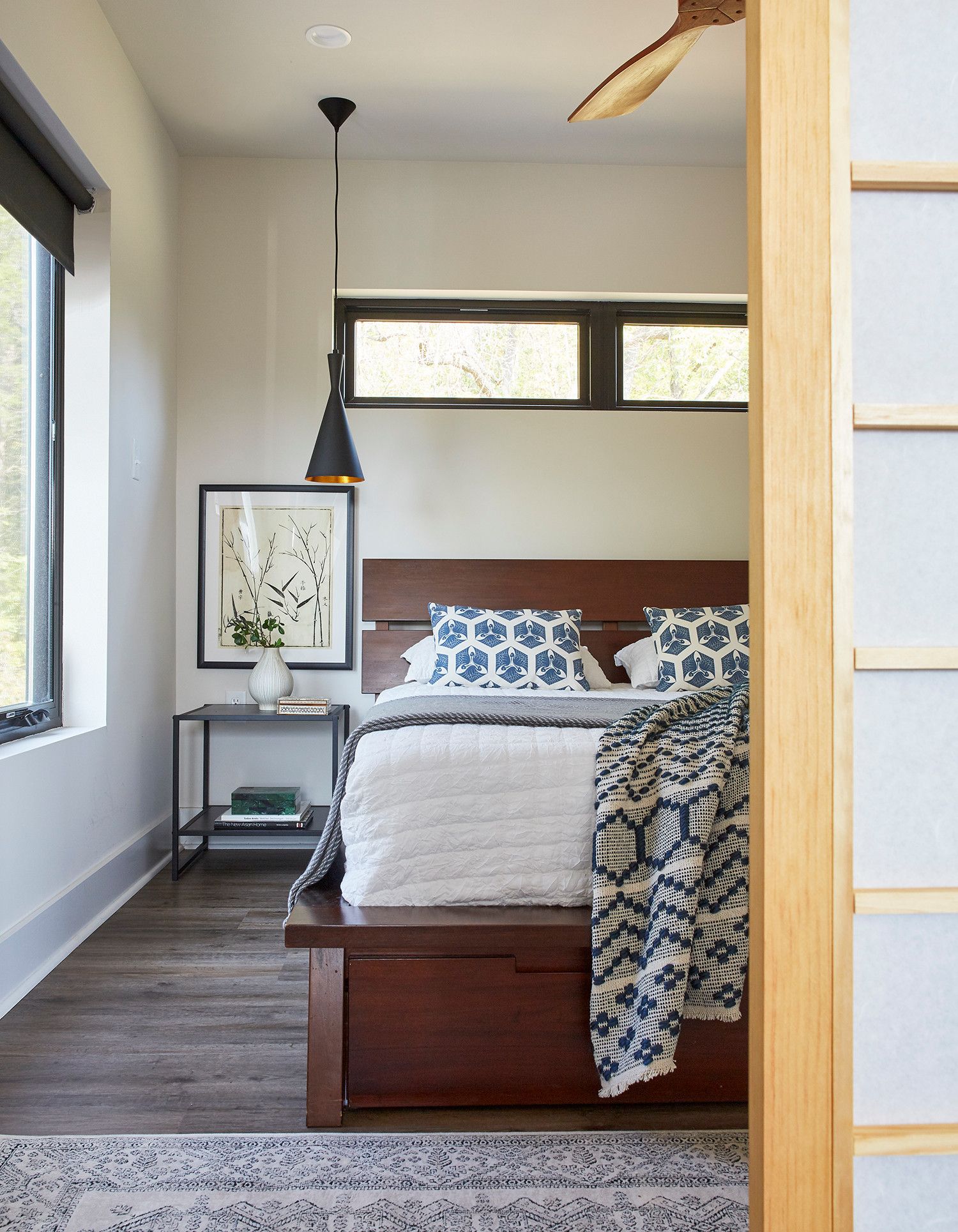 Dashing Tom Dixon pendant used as bedside lighting in the small urban bedroom with sliding door