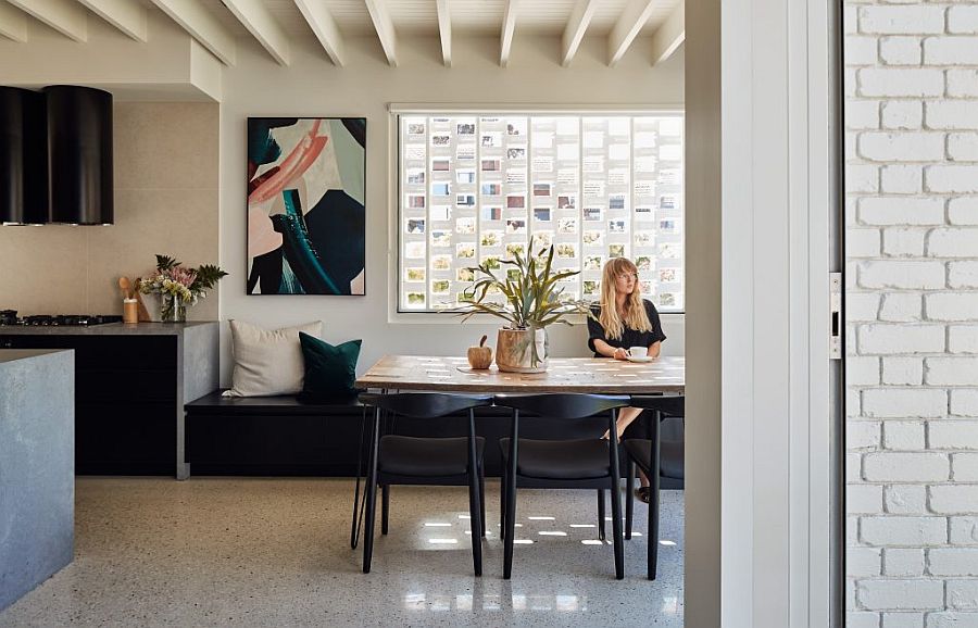 Dining area with natural wood table, dark black chairs and other smart seating options