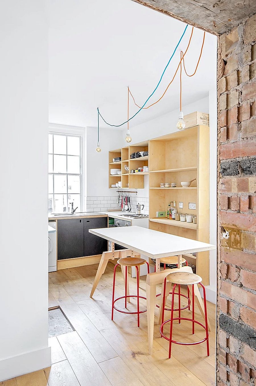 Fabulous bar stools in red and wood add color and class to the kitchen