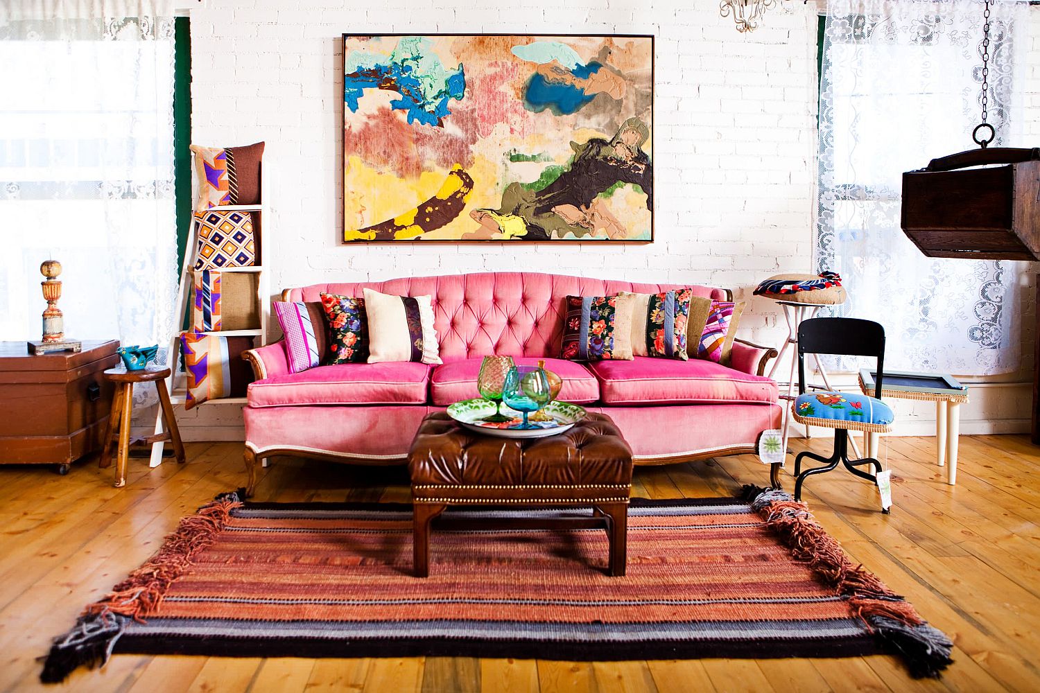 Fabulous pink sofa anchors this exquisite brick wall living room with eclectic style