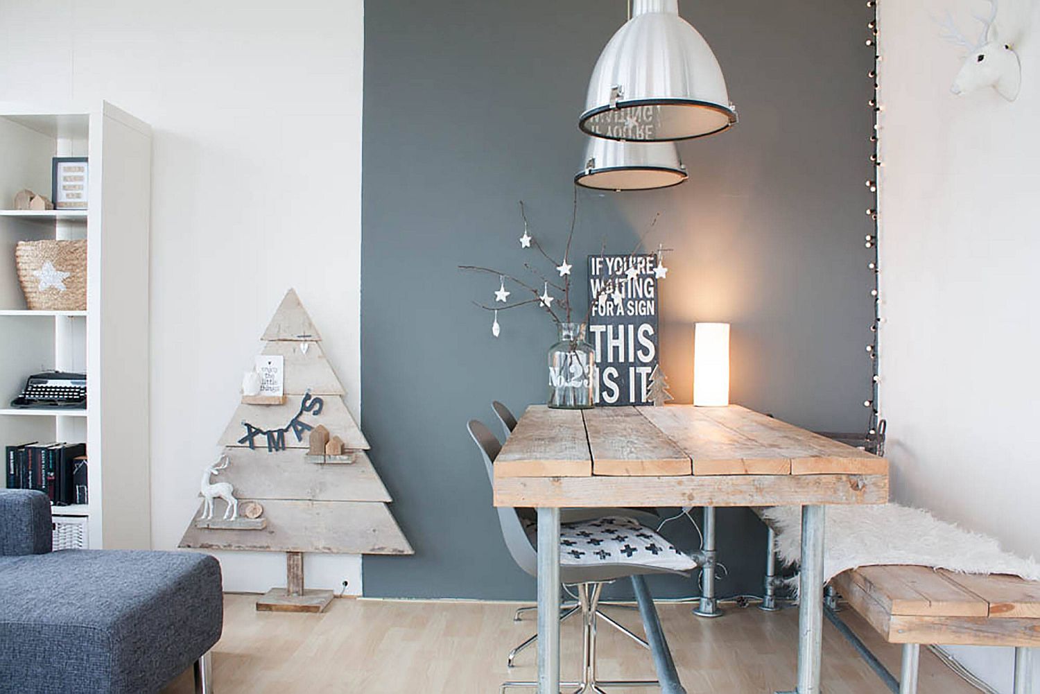 Festive gray and white dining room with a unique Christmas tree and modern Scandinavian style