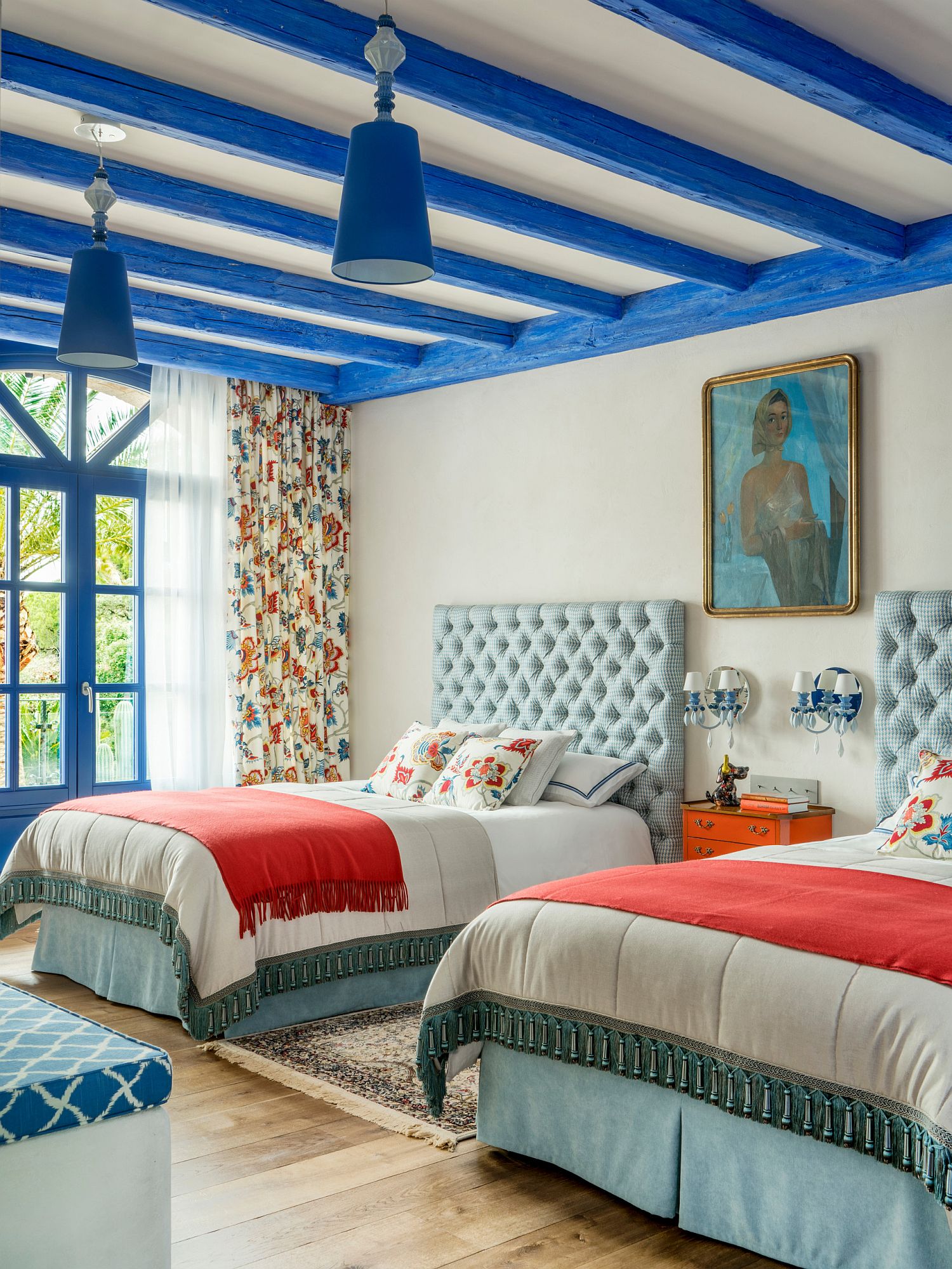 Gorgeous ceiling beams in blue bring color to the spacious modern Mediterranean kids' room