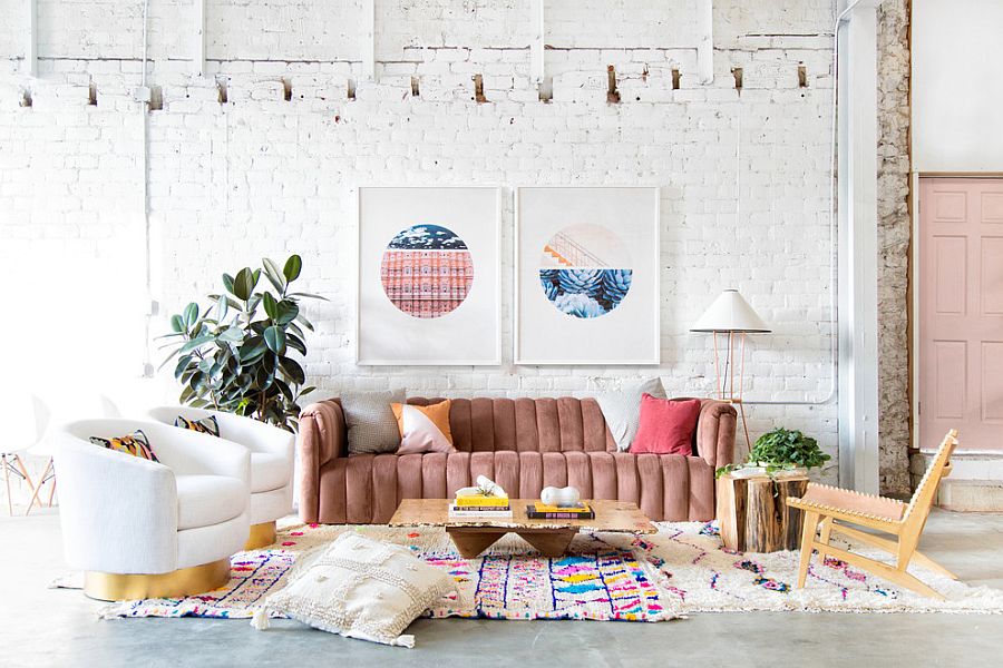Gorgeous modern eclectic living room with pops of pink, metallic accents and whitewashed brick wall in the backdrop