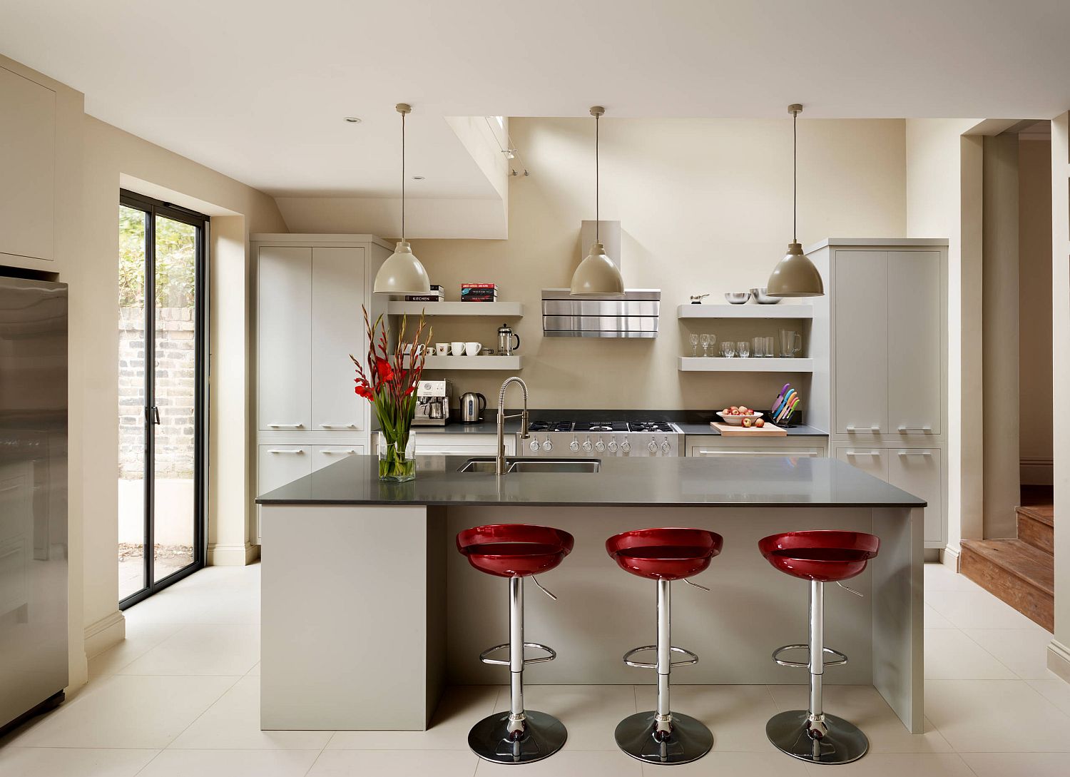 white kitchen with red bar stools