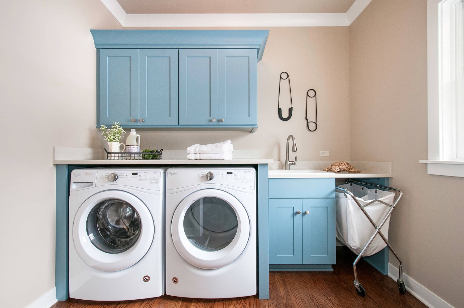 Gorgeous transitional laundry room in white and blue with landry bag and much more