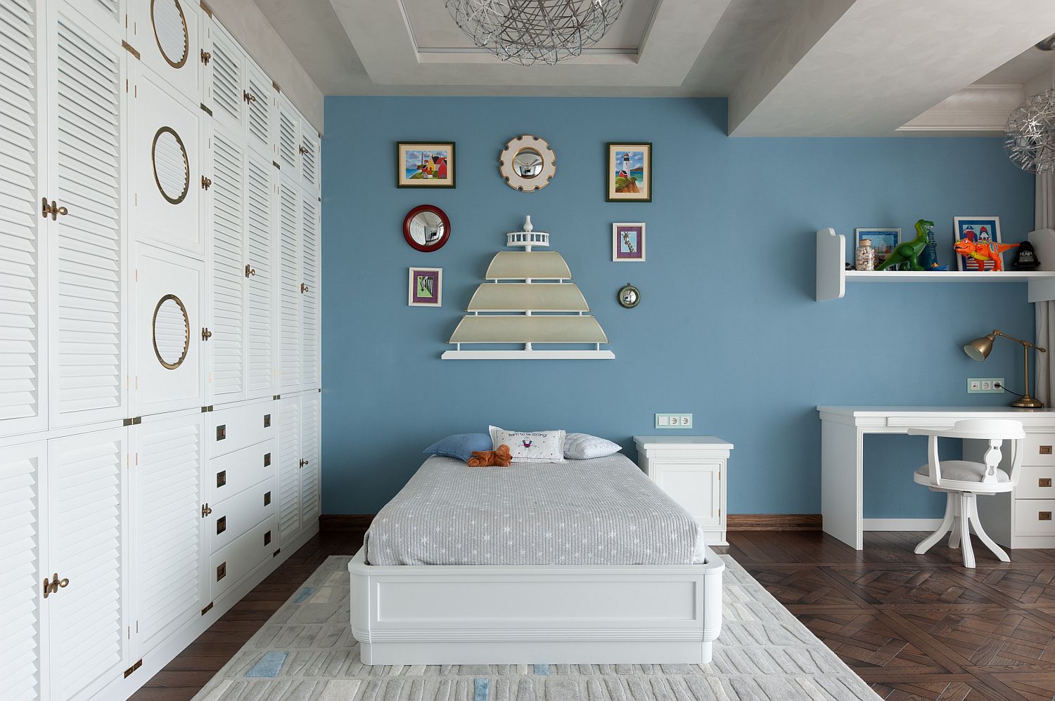 Gray and white kids' bedroom with accent wall in blue