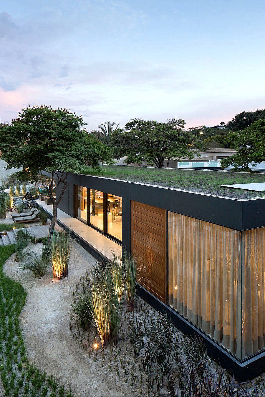 Green roof of the prefab coupled with solar panels powers the home