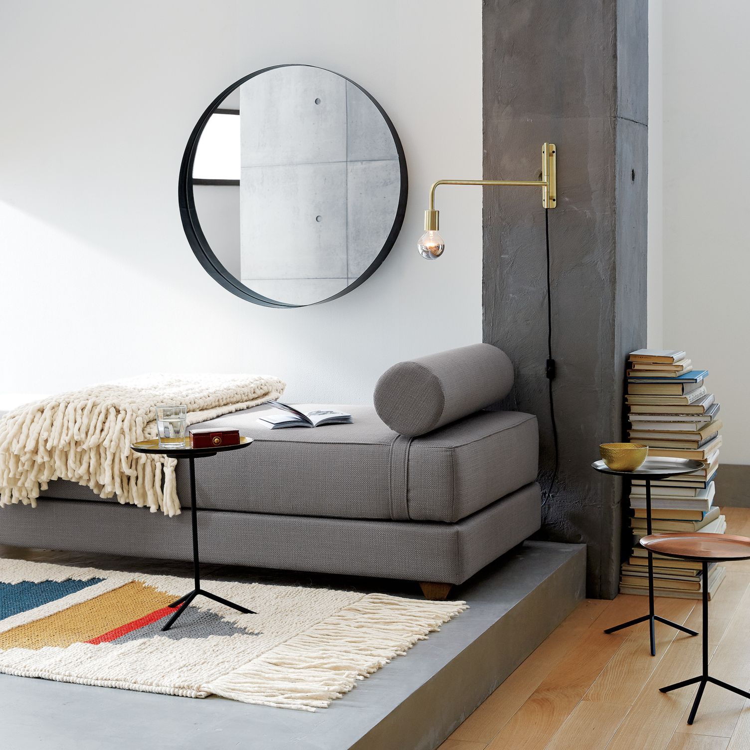 Grey daybed with a cylinder pillow