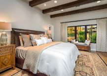 Mediterranean-style-bedroom-with-dark-wooden-ceiling-beams-and-a-neutral-color-scheme-217x155