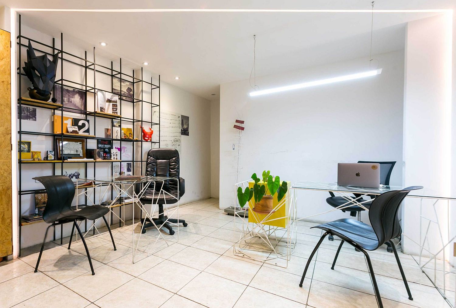 Metal frame shelf and colorful accents add industrial modern look to the small office