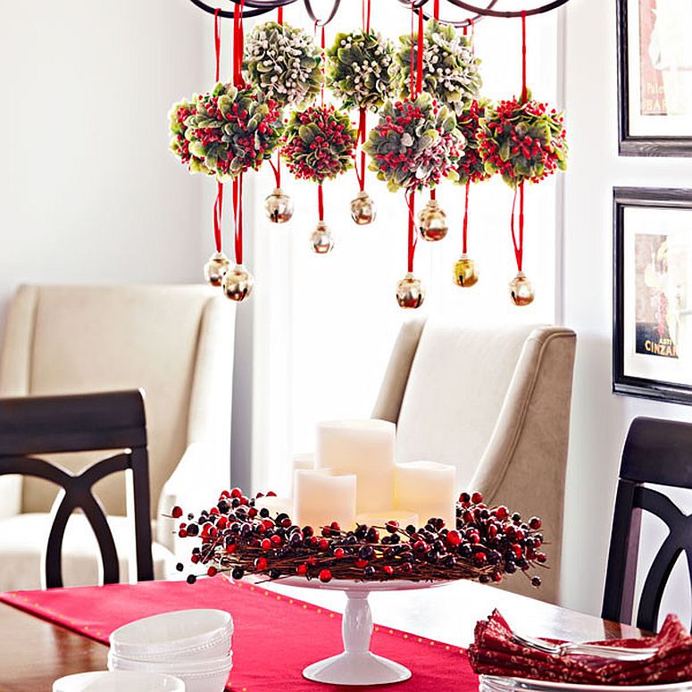 Mistle toe balls and bells hanging from the chandelier make for a fun festive decorative piece