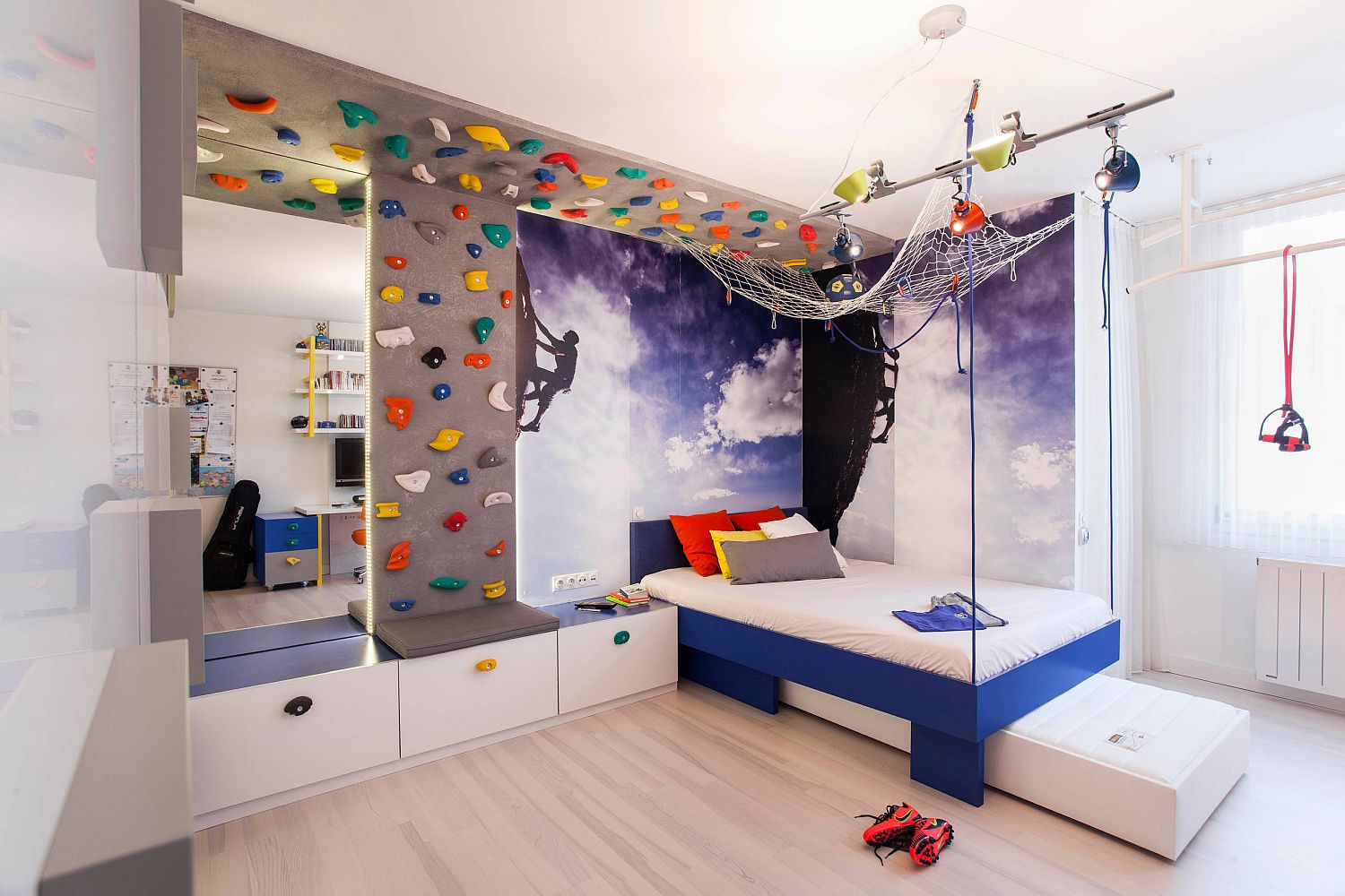 Moving-the-bed-to-the-corner-frees-up-space-in-the-modern-kids-bedroom-with-climbing-wall