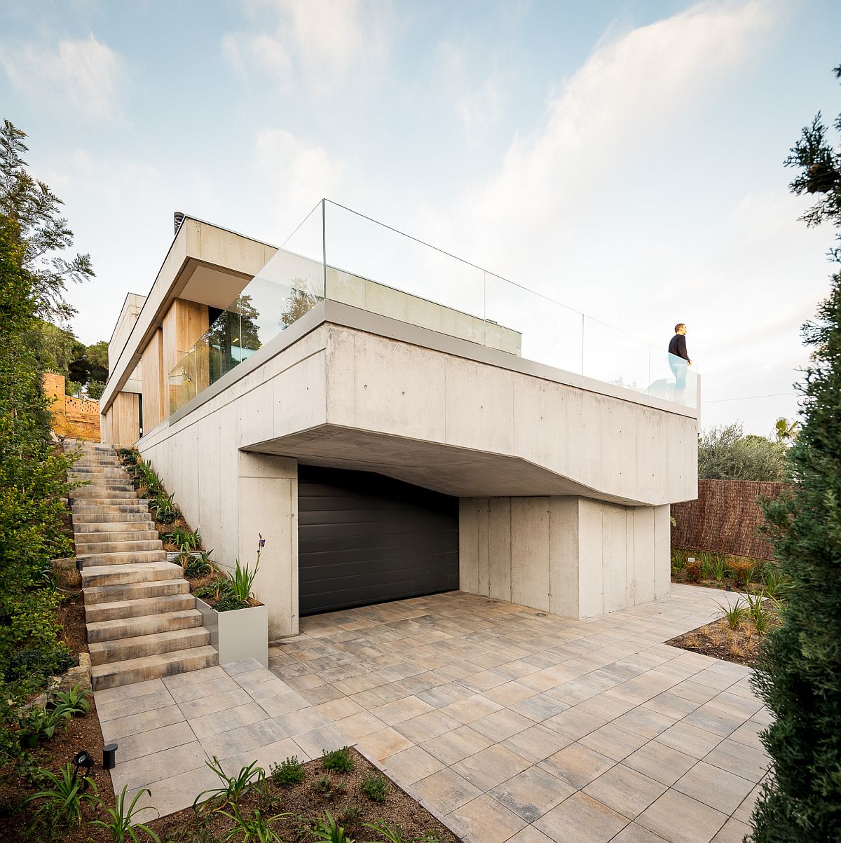 Multi-level Spanish home in concrete, wood and glass with a sheltered entrance