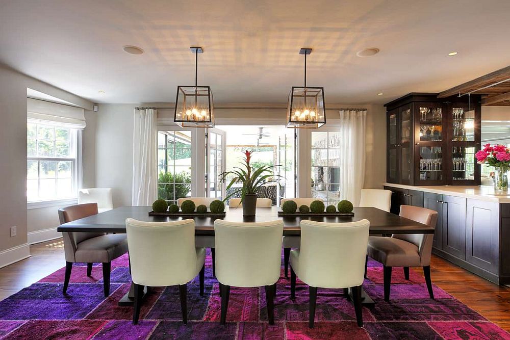 Patchwork pattern rug in pink and purple is the real showstopper in this dining room