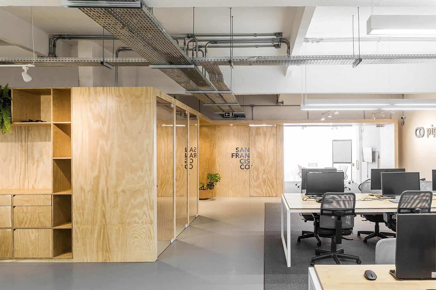 Raw concrete wood, and industrial elements give this office a modern rustic look