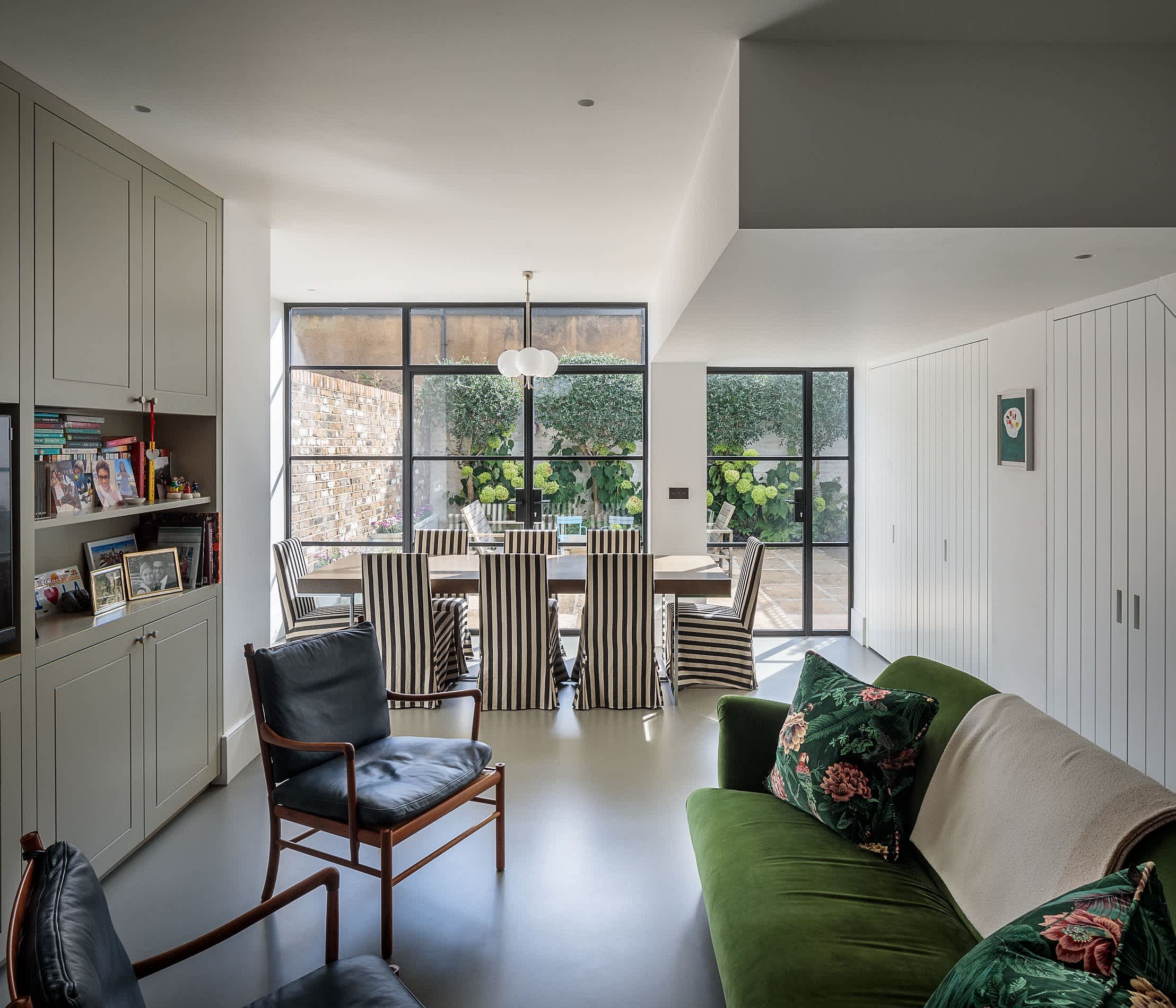 Revamped interior of the Willow house with a neutral color scheme and bright couch in green