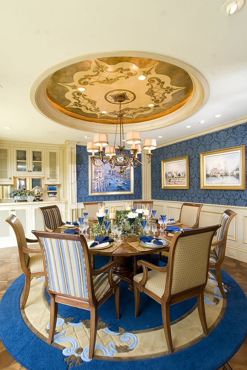 Round and blue rug in the classic beach style dining room complements other hues and patterns in the space