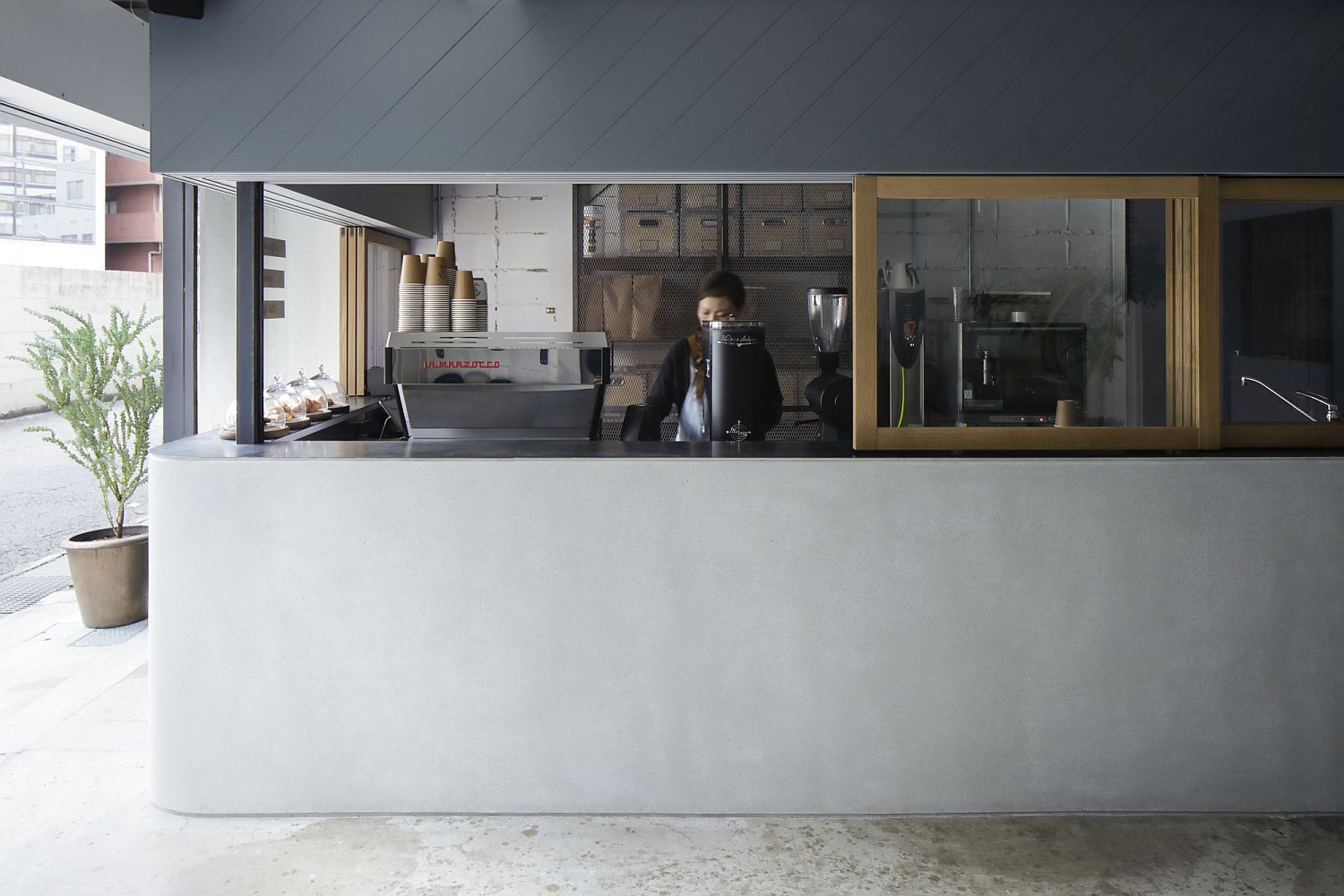 Simple and unassuming design of the coffee shop with white and blue interior