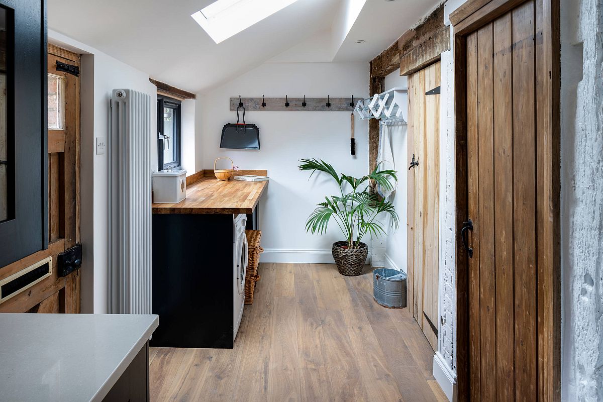 cottage style laundry room with rustic barn doors and countertop