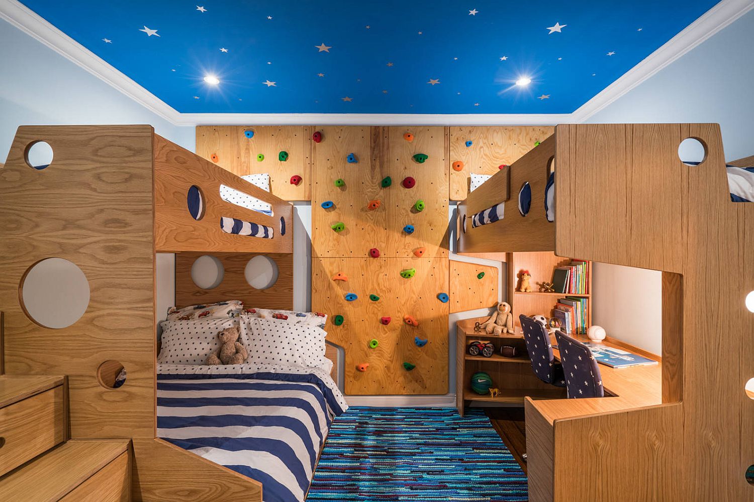 Small-and-space-savvy-kids-bedroom-design-with-blue-ceiling-bunk-beds-and-climbing-wall.jpg