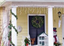 Snowman-string-lighting-and-a-holiday-wreath-transform-this-small-porch-area-into-a-festive-space-217x155