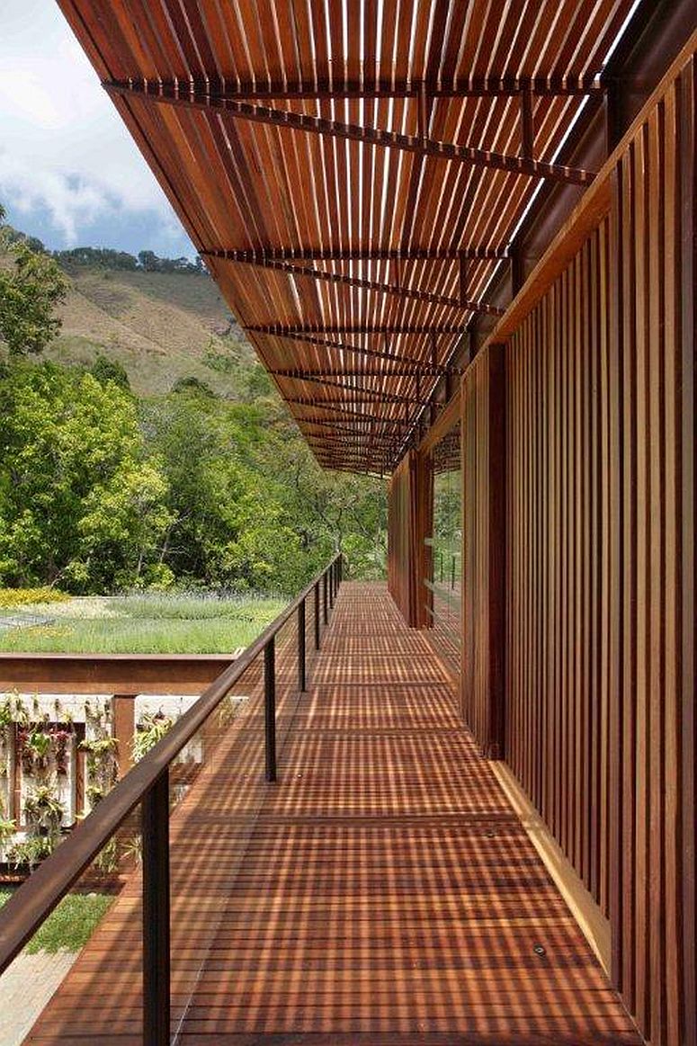 Spacious and slim wooden deck on the upper level with a view of the landscape