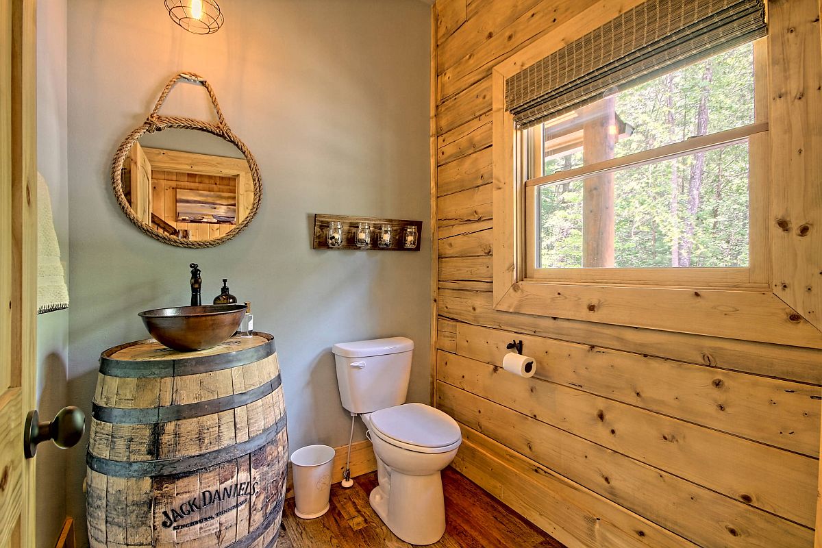 Tiny rustic bathroom with log cabin style and plenty of woodsy charm