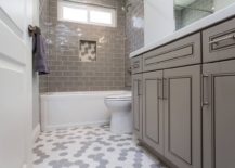 Transitional-style-bathroom-vanity-in-gray-along-with-white-and-gray-hexagonal-floor-tiles-217x155