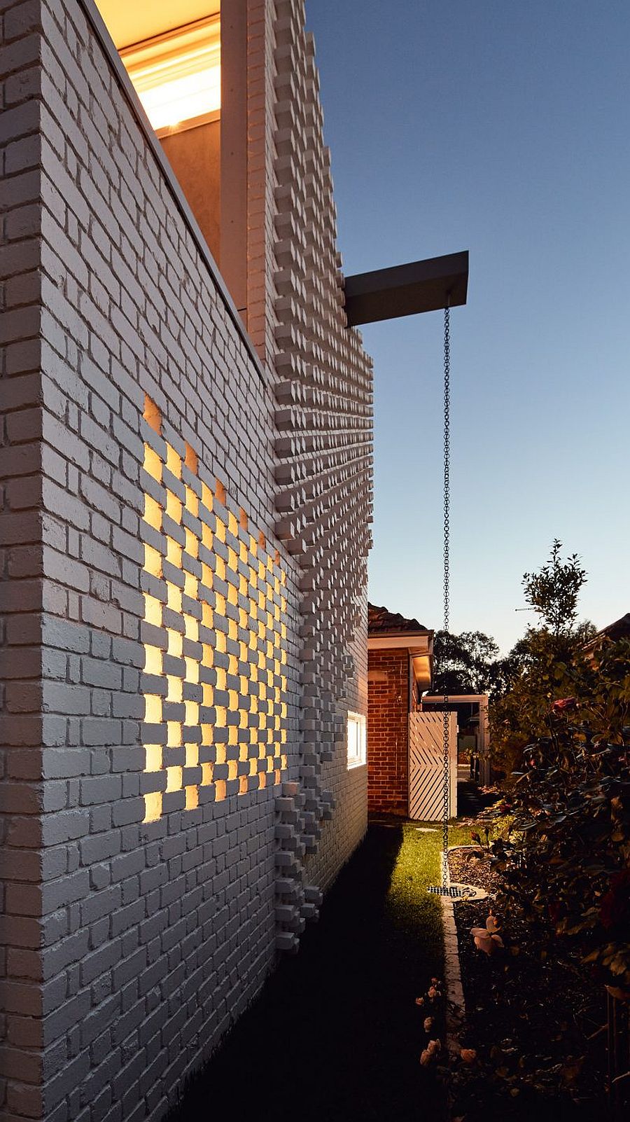 Unique-brick-wall-extension-with-rain-chain-and-other-green-features-that-make-it-planet-friendly