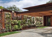 Vertical-garden-and-floweing-plants-bring-an-additional-layer-of-greenery-to-the-entrance-217x155