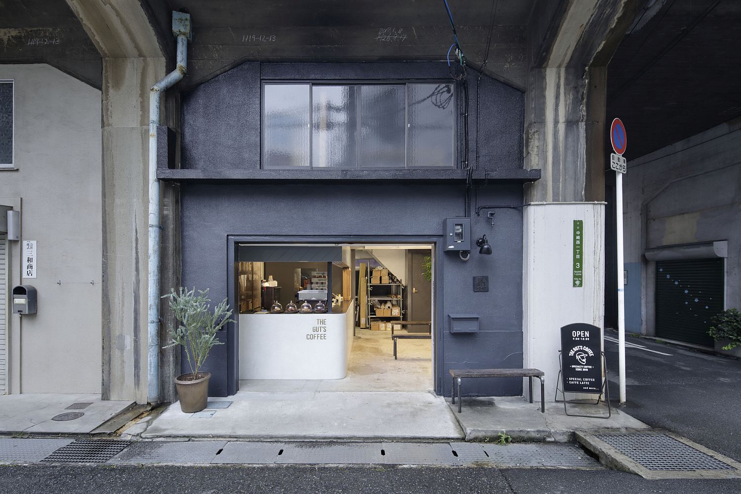 View from the street of the gorgeous modern coffee shop inside revamped industrial warehouse