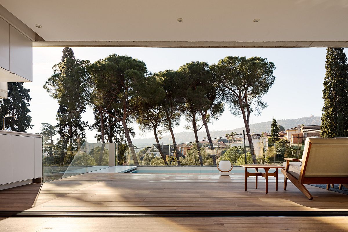 View of the deck, pool area and the landscape beyond from the living space